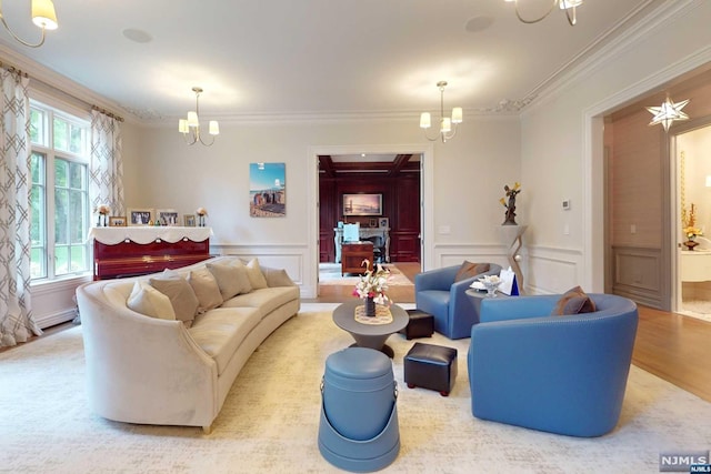 living room featuring hardwood / wood-style floors, ornamental molding, and a chandelier