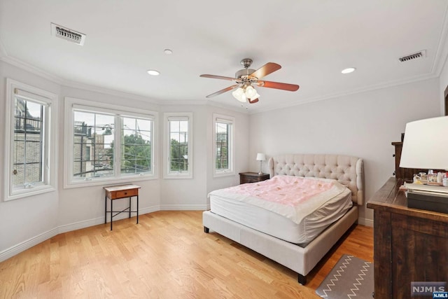 bedroom with multiple windows, ceiling fan, light hardwood / wood-style floors, and ornamental molding