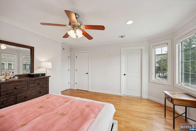 bedroom with ceiling fan, light wood-type flooring, and ornamental molding