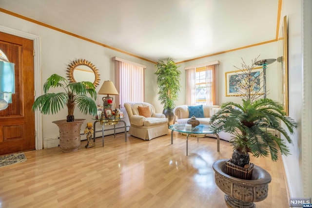 interior space with crown molding, a baseboard heating unit, and hardwood / wood-style flooring