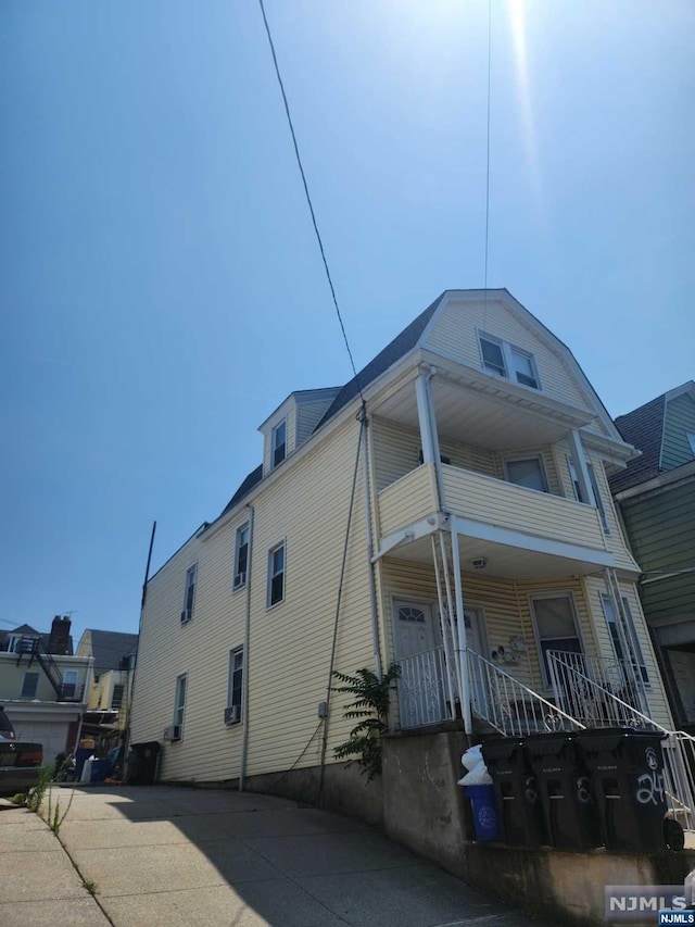 exterior space featuring covered porch and a balcony