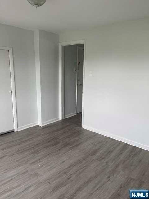 empty room featuring dark wood-type flooring