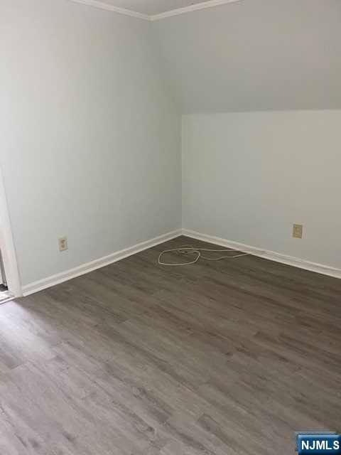 bonus room featuring lofted ceiling and dark hardwood / wood-style floors