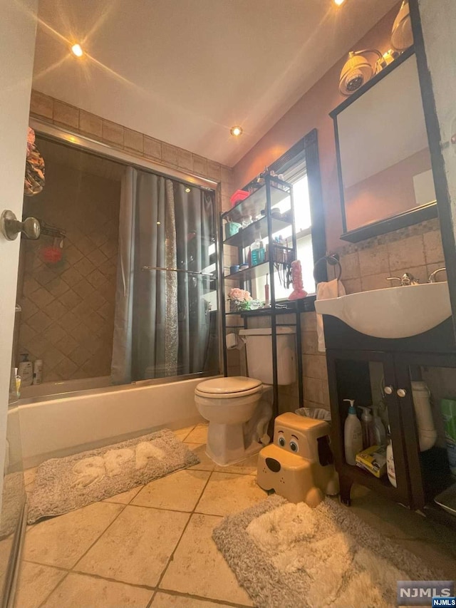 full bathroom with shower / bath combination with curtain, toilet, tile patterned floors, and sink