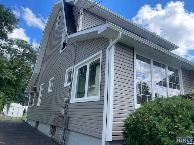 view of property exterior with an AC wall unit