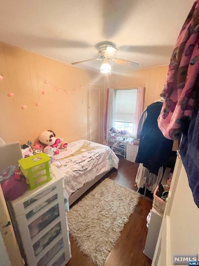 bedroom with ceiling fan and dark hardwood / wood-style flooring