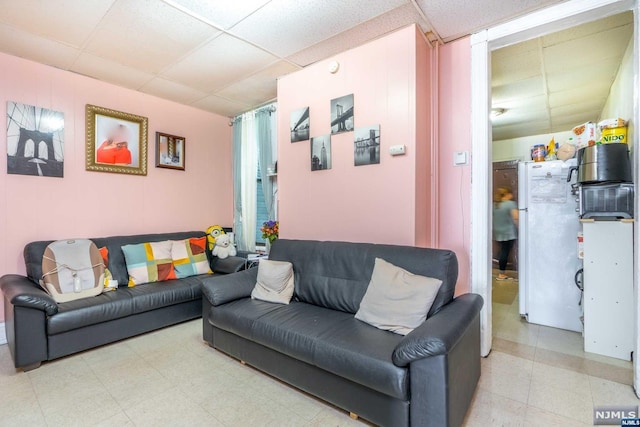 living room featuring a paneled ceiling