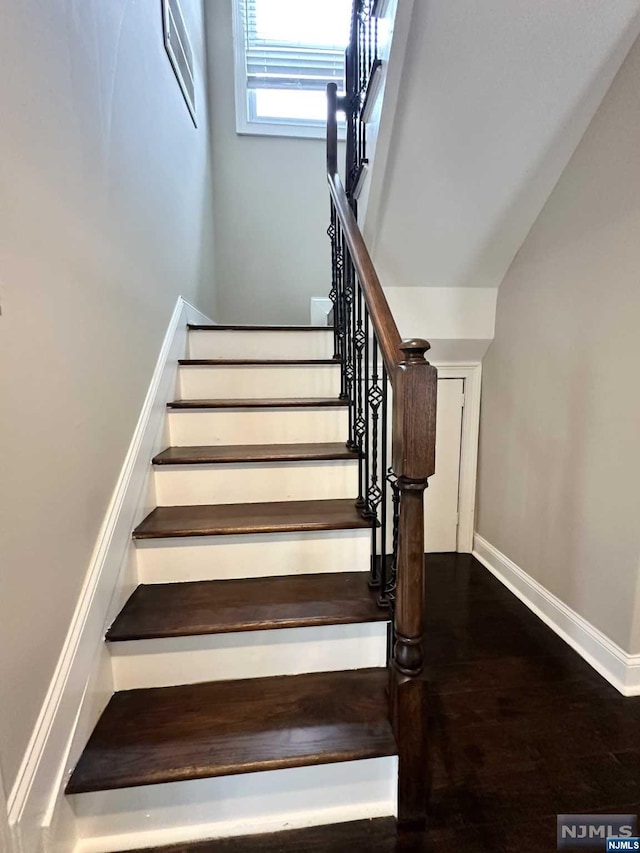 stairway with hardwood / wood-style floors