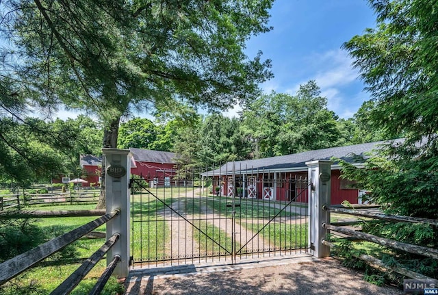 view of gate with an outbuilding