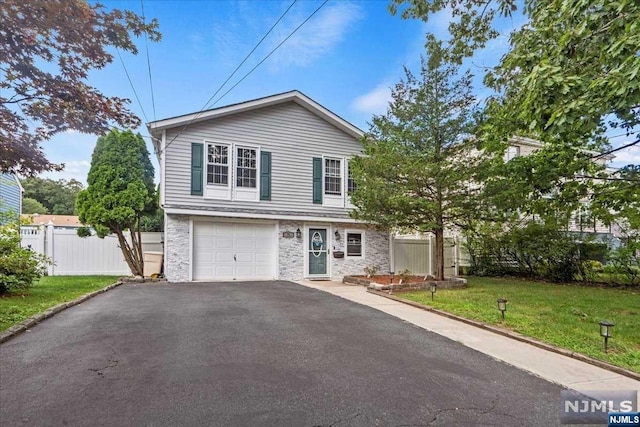 view of front of property with a garage and a front lawn