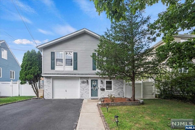 view of front of house featuring a garage and a front lawn