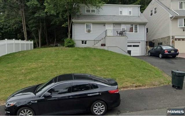 view of front of property featuring a garage and a front lawn