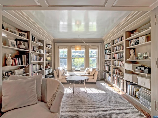 sitting room with carpet, built in features, and ornamental molding