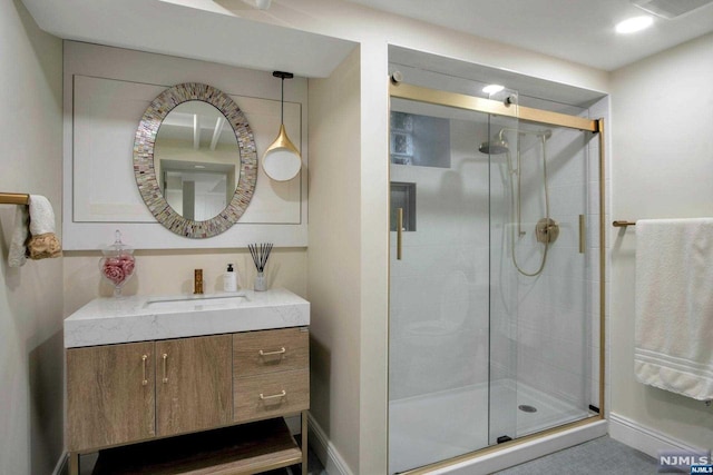 bathroom featuring vanity and a shower with shower door