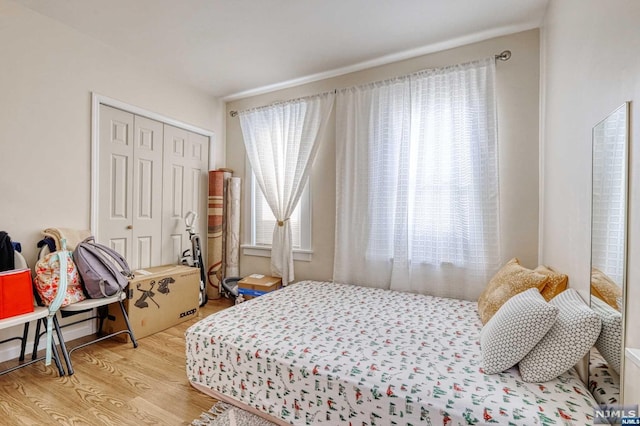 bedroom featuring a closet and light wood-type flooring