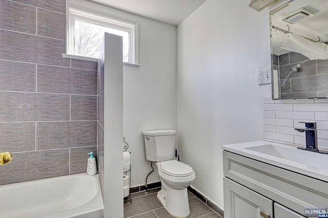 full bathroom featuring vanity, toilet, and tiled shower / bath combo