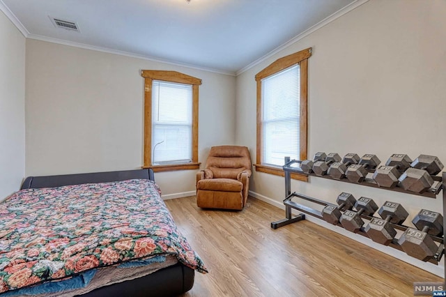 bedroom featuring crown molding and light wood-type flooring