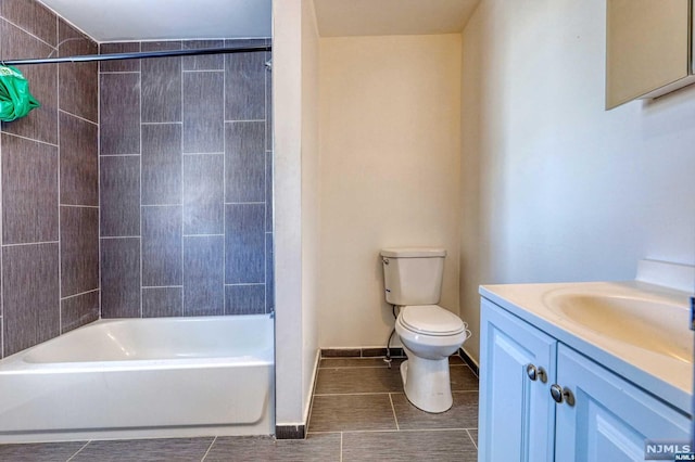 full bathroom featuring vanity, tile patterned floors, tiled shower / bath combo, and toilet