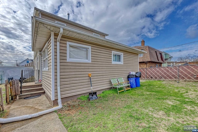 view of side of property with a lawn