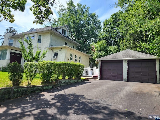 view of front of home with an outdoor structure and a garage