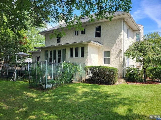 rear view of house featuring a yard