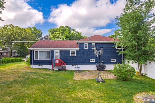 rear view of property featuring a yard