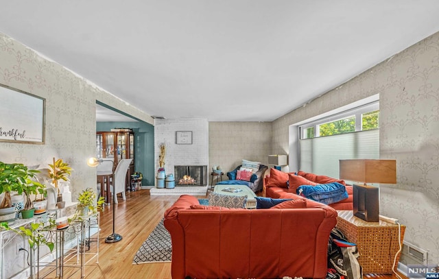 living room with hardwood / wood-style flooring and a fireplace