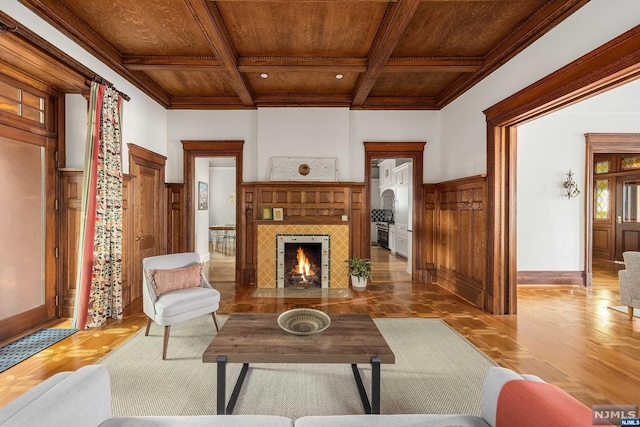 living room featuring beam ceiling, hardwood / wood-style flooring, crown molding, and wood ceiling