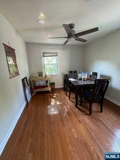 dining room with hardwood / wood-style floors and ceiling fan