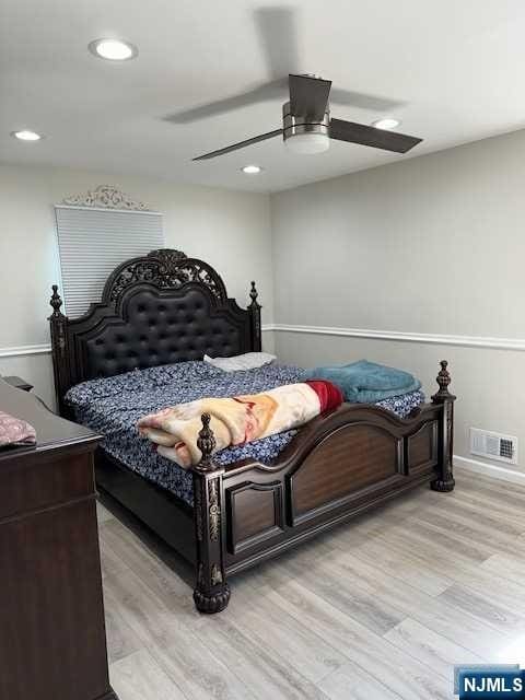 bedroom featuring ceiling fan and light hardwood / wood-style flooring