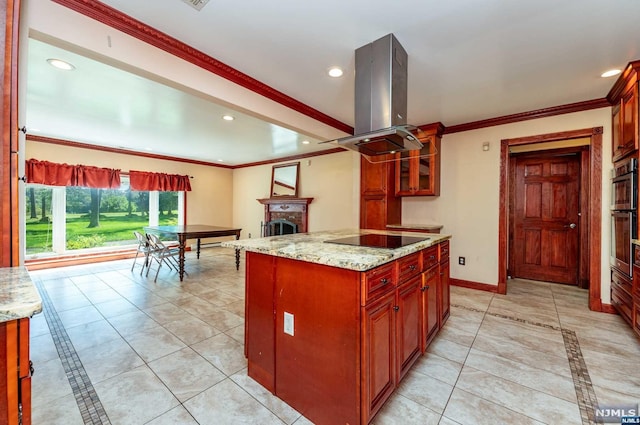 kitchen featuring black electric stovetop, a center island, light stone countertops, and island exhaust hood