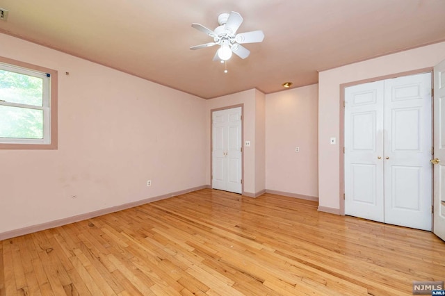 unfurnished bedroom featuring ceiling fan and light hardwood / wood-style floors