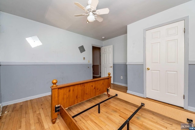 bedroom with ceiling fan and light wood-type flooring