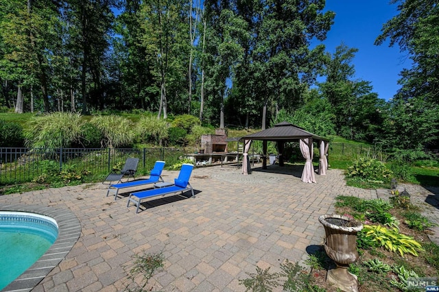 view of patio / terrace featuring a gazebo and a fenced in pool