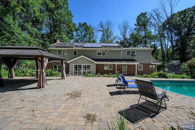 view of swimming pool featuring a gazebo and a patio