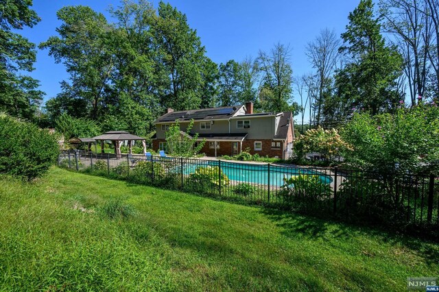 view of pool featuring a gazebo and a yard