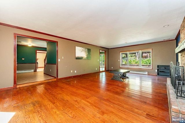 unfurnished living room featuring baseboard heating, a fireplace, hardwood / wood-style floors, and ornamental molding