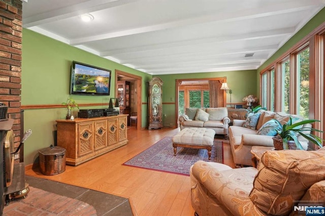 living room featuring hardwood / wood-style flooring and beamed ceiling