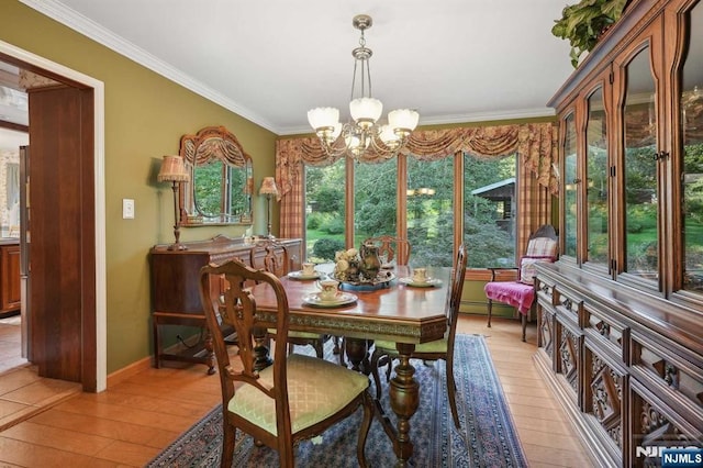 dining room featuring ornamental molding, an inviting chandelier, and light hardwood / wood-style flooring