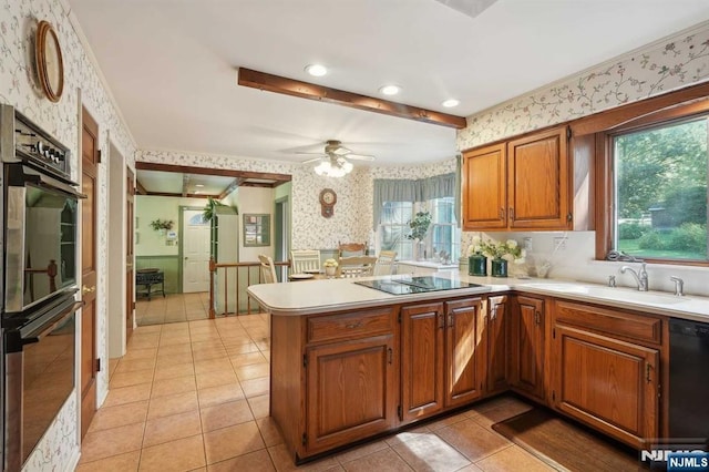 kitchen featuring kitchen peninsula, black appliances, sink, ceiling fan, and light tile patterned flooring