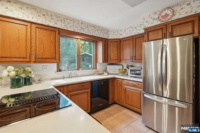 kitchen with sink, black appliances, and light tile patterned flooring