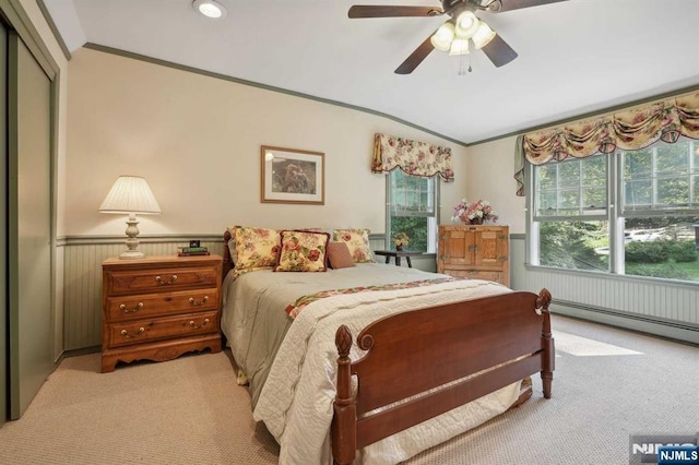 carpeted bedroom featuring a baseboard radiator, ornamental molding, and ceiling fan