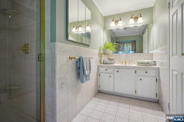 bathroom featuring an enclosed shower, tile patterned floors, ornamental molding, tile walls, and vanity