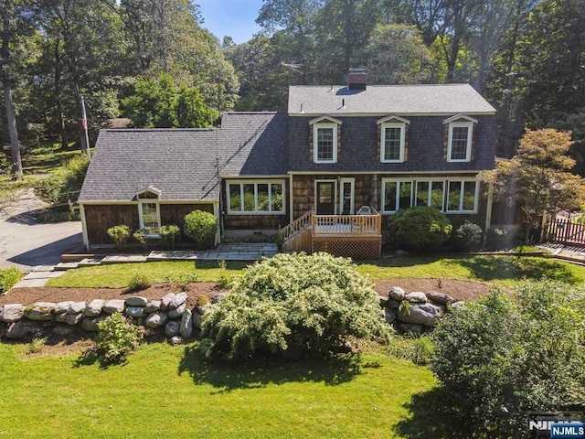 view of front of property with a deck and a front yard