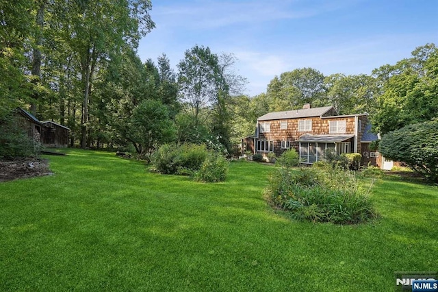 view of yard with a sunroom