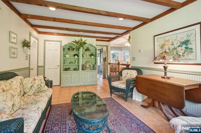 tiled living room featuring beamed ceiling