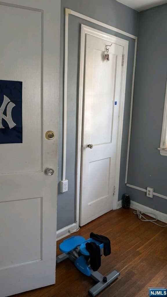 entryway with dark wood-type flooring