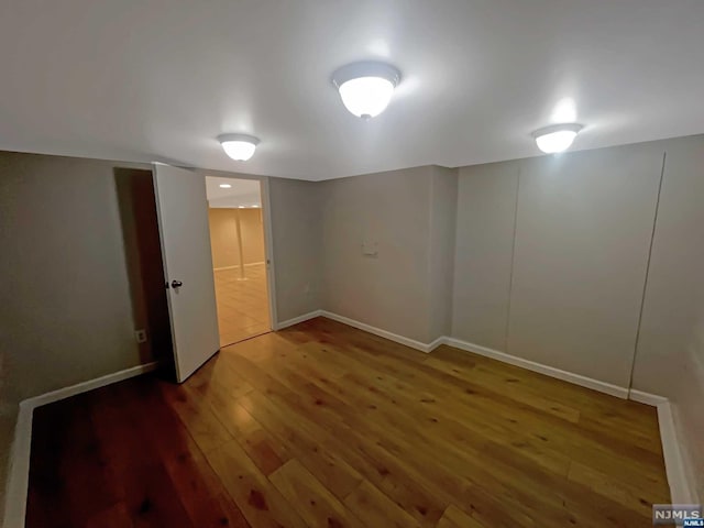 unfurnished room with hardwood / wood-style floors