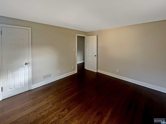 unfurnished room featuring dark hardwood / wood-style floors