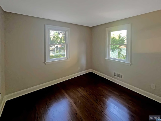 unfurnished room featuring dark hardwood / wood-style floors